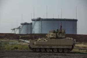 A M2 Bradley, with Alpha Troop, 1st Battalion, 6th Infantry Regiment, 2nd Armored Brigade Combat Team, 1st Armored Division, scans for threats near an oil refinery in Northeast Syria.