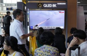 A TV screen shows a file image of North Korea's missile launch.