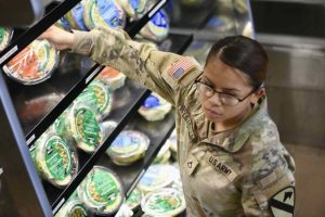 U.S. Army soldier grabs a salad from a Culinary Outpost kiosk
