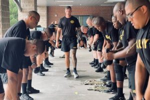 Soldiers in the fitness track of the Army's pre-basic prep course doing circuit training with kettlebells.
