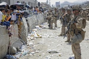 U.S. Marines with Special Purpose Marine Air-Ground Task Force - Crisis Response - Central Command assist during an evacuation at Hamid Karzai International Airport in Kabul, Afghanistan.