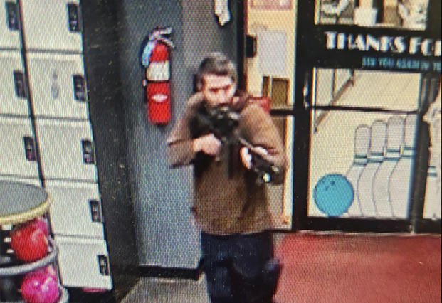unidentified gunman points a gun while entering Sparetime Recreation in Lewiston, Maine
