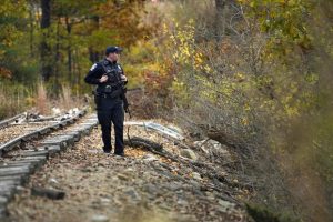 Police officer searches for suspect after deadly mass shootings in Maine