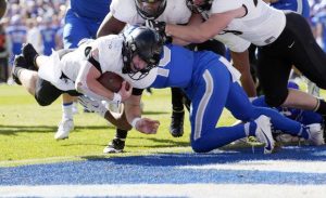 Army quarterback Bryson Daily, left, dives into the end zone.