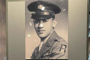 Exhibit featuring Waverly Bernard Woodson Jr. at Normandy American Cemetery visitors center