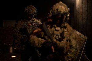 U.S. Army Special Forces (USSF) raid a mock hostile compound under the cover of darkness