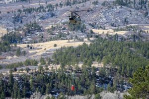 Firefighters from the U.S. Air Force Academy, Fort Carson and the Colorado Springs Fire Department dump water from air assets in their fight against the West Monument Creek Fire on the U.S. Air Force Academy.