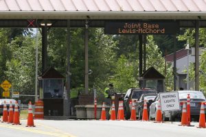 Cars enter Joint Base Lewis-McChord, Wash.