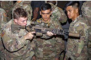 U.S. Army soldiers assigned to the 2nd Infantry Brigade Combat Team, 25th Infantry Division, observe a Next-Generation Squad Weapon (NGSW) machine gun with fire control during a Program Executive Office Soldier Operational Kit demonstration at Schofield Barracks, Hawaii.
