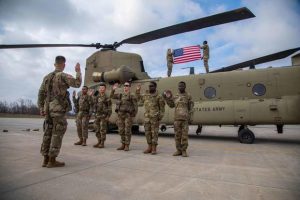 Reenlistment ceremony in front of a CH-47 Chinook at Fort Drum