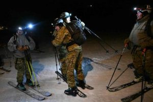 10th Mountain Division skiers hug one another