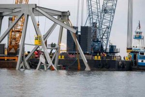 Demolition crews cut the top portion of collapsed Francis Scott Key Bridge