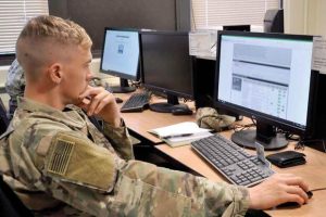 Soldier works on a computer