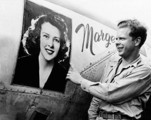 Captain Richard J. Bong points to a large picture of his girlfriend