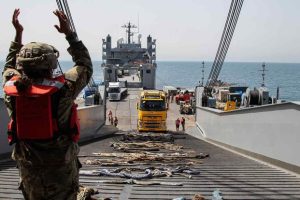 A U.S. Army soldier guides a aid truck bound for Gaza