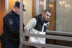 U.S. Army Staff Sgt. Gordon Black is escorted into a glass cage in a courtroom in Vladivostok