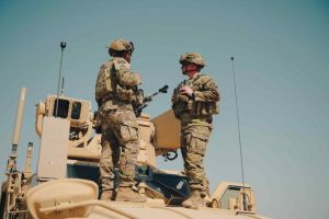 U.S. Army soldiers on top of a Mine Resistant Ambush Protected All-Terrain Vehicle