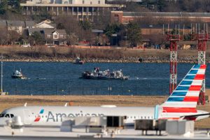 Police and Coast Guard boats are seen around a wreckage site in the Potomac River.