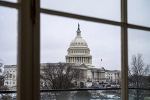 Capitol seen through a window in the Cannon House Office Building