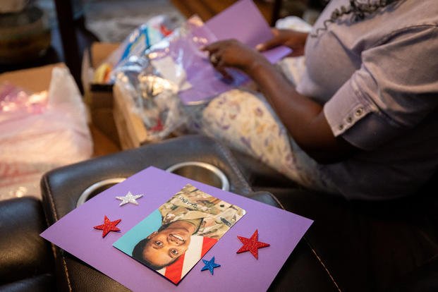 20250523-AMX-US-NEWS-HER-CELLPHONE-VANISHED-LETHAL-DRONE-7-AT.jpg Oneida Oliver-Sanders, mother of Army Reserve Sgt. Kennedy L. Sanders, makes Memorial Day craft packages for elementary school students at her home in Waycross, Georgia.