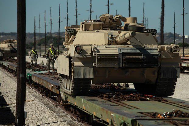 mil-M1A1-abrams-transportation-railcar-1800.jpg Soldiers guide an M1A1 Abrams on to a equipment transportation railcar