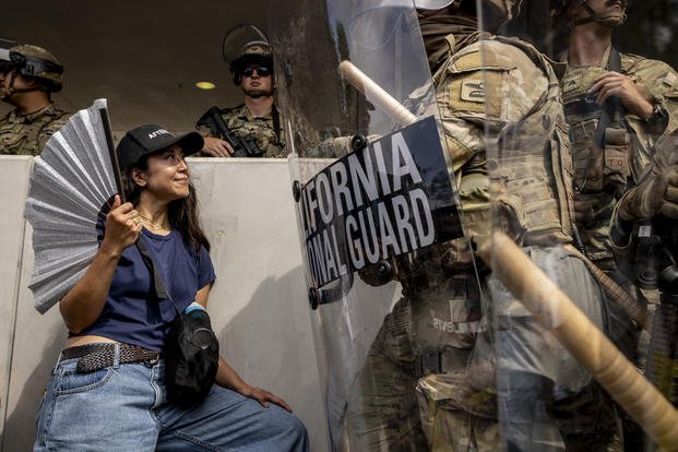 ApNewsroom_US_Protests_Los_Angeles_23881.jpg Protester standing in front of a California National Guard