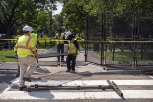 Workers put up fencing around Dupont Circle ahead of the World Pride Parade