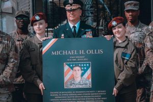 Brig. Gen. Eric Riley, deputy commanding general, 10th Mountain Division, poses with soldiers from 10th Mountain Division and uniformed students from the Staff Sgt. M. Ollis Junior Training Corps in front of the Tomb of the Unknown Soldier after a wreath-laying ceremony in Warsaw, Poland.