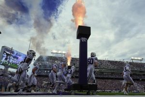 Kansas State players run onto the field before an NCAA college football game against North Dakota.