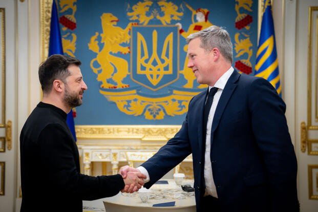 Ukrainian President Volodymyr Zelenskyy shakes hands with U.S. Secretary of the Army Dan Driscoll.